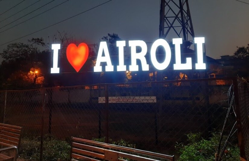 Airoli_a neon sign on a pole at night